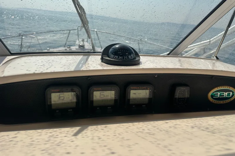 R & R Yacht Photos Pics Dashboard of a 2008 Grady White Express boat with gauges and compass.