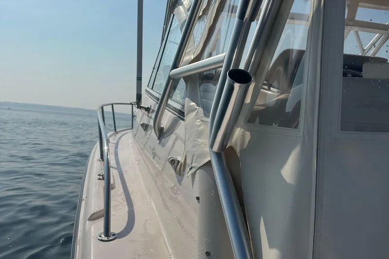 R & R Yacht Photos Pics 2008 Grady White Express boat on calm water, showcasing sleek design and metal railings.