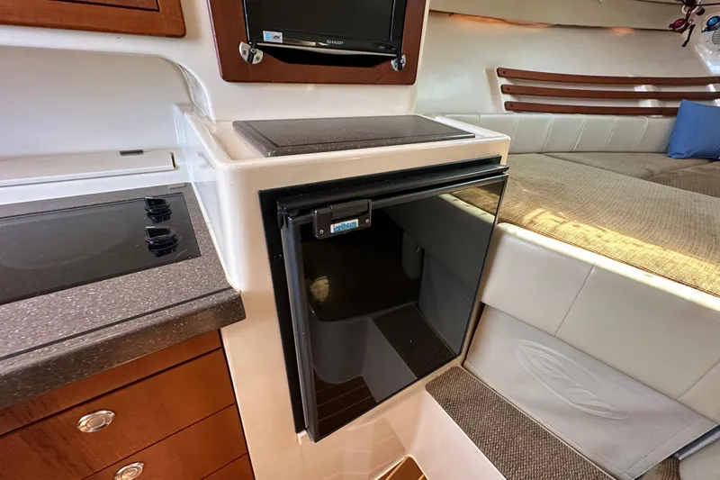 R & R Yacht Photos Pics 2008 Grady White Express interior with kitchenette, fridge, and cozy seating area.