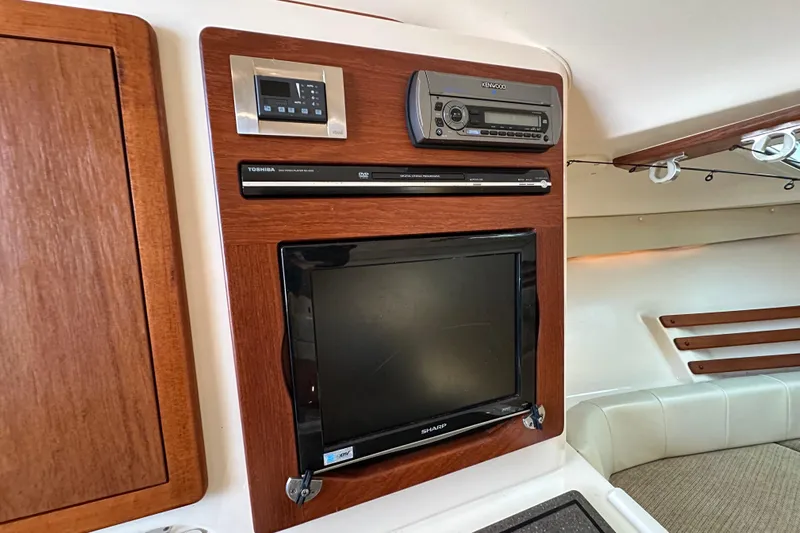 R & R Yacht Photos Pics 2008 Grady White Express interior with TV, DVD player, and stereo system.