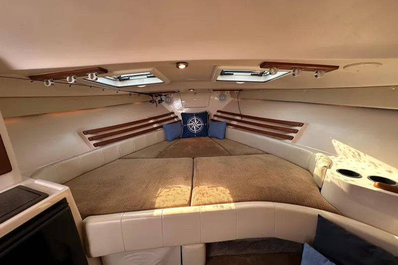 R & R Yacht Photos Pics 2008 Grady White Express cabin interior with cozy seating and nautical decor.