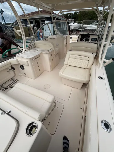 Sweetness Yacht Photos Pics 2021 Grady-White Freedom 285 boat interior with seating and helm, docked at marina.