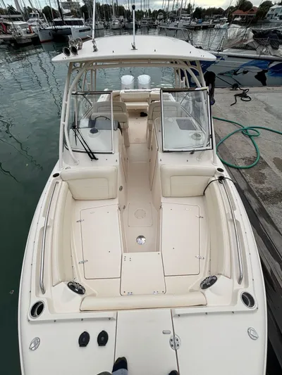 Sweetness Yacht Photos Pics 2021 Grady-White Freedom 285 boat docked at marina, showcasing spacious seating and helm.