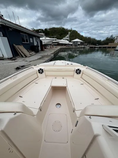 Sweetness Yacht Photos Pics 2021 Grady-White Freedom 285 boat docked, showcasing spacious seating and sleek design.