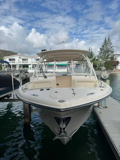 Sweetness Yacht Photos Pics 2021 Grady-White Freedom 285 boat docked at marina under cloudy sky.