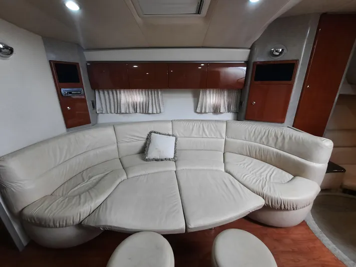 Paradox Yacht Photos Pics 2008 Formula 40 PC yacht interior with curved leather seating and wooden cabinets.