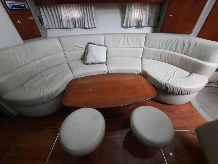 Paradox Yacht Photos Pics 2008 Formula 40 PC yacht interior with curved leather seating and wooden table.