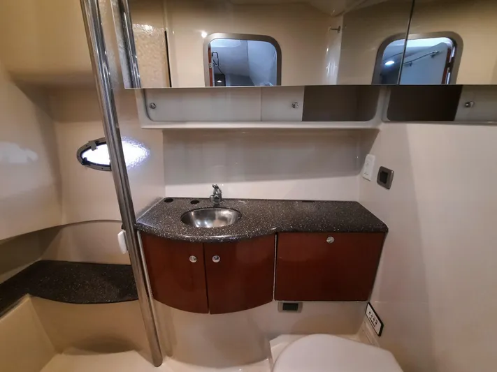 Paradox Yacht Photos Pics 2008 Formula 40 PC bathroom with sink, mirror, and storage cabinets.