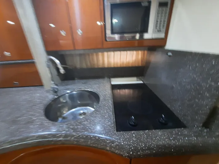 Paradox Yacht Photos Pics 2008 Formula 40 PC yacht kitchen with sink, stovetop, and microwave.
