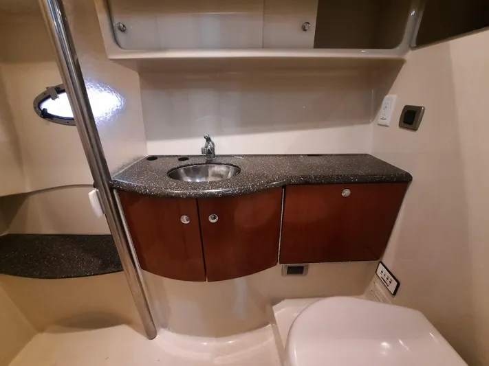 Paradox Yacht Photos Pics 2008 Formula 40 PC yacht bathroom with sink, countertop, and storage cabinets.