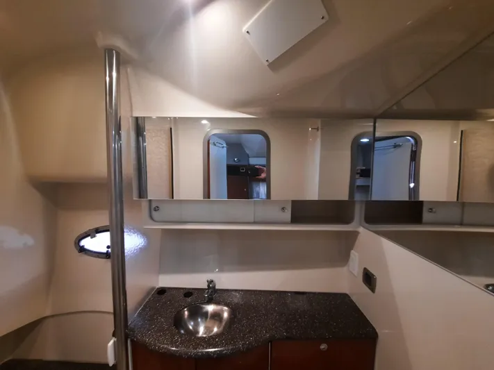 Paradox Yacht Photos Pics 2008 Formula 40 PC yacht bathroom with sink, mirror, and porthole window.