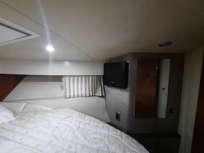 Paradox Yacht Photos Pics Interior cabin of a 2008 Formula 40 PC yacht with bed and TV.