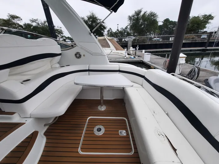 Paradox Yacht Photos Pics 2008 Formula 40 PC yacht with white seating and wooden deck at a marina.