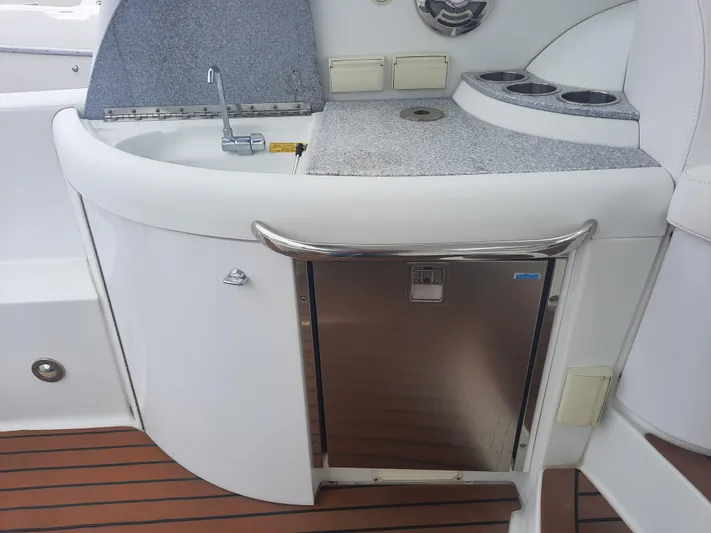 Paradox Yacht Photos Pics 2008 Formula 40 PC boat kitchenette with sink, countertop, and mini fridge.