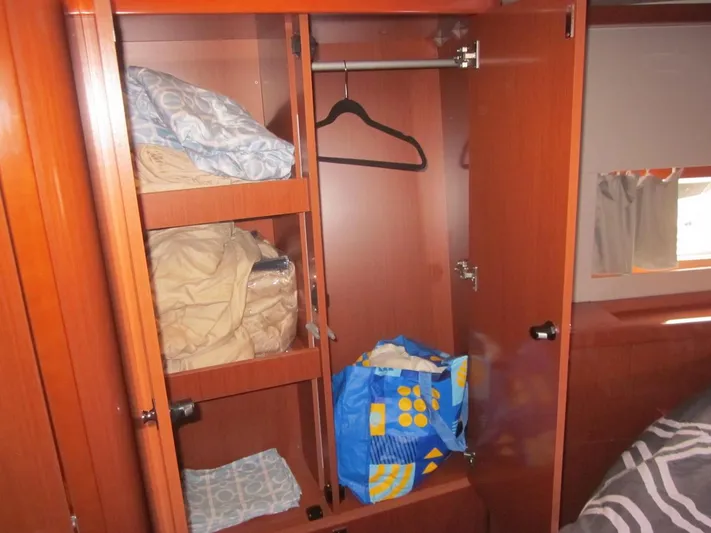 Cameli Yacht Photos Pics Wardrobe interior on 2020 Beneteau Oceanis 55 yacht with shelves and hanging space.