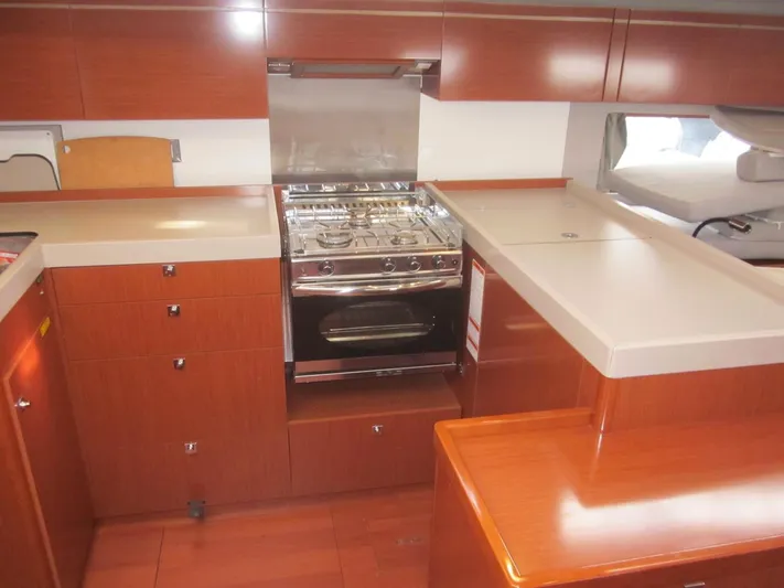 Cameli Yacht Photos Pics Modern kitchen in 2020 Beneteau Oceanis 55 yacht with wood cabinetry and stainless steel appliances.
