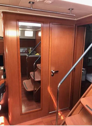 Cameli Yacht Photos Pics Interior of 2020 Beneteau Oceanis 55 yacht with wooden finish and staircase.