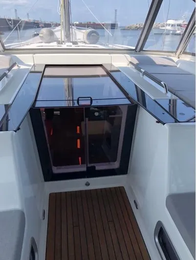 Cameli Yacht Photos Pics 2020 Beneteau Oceanis 55 yacht cockpit with wooden flooring and glass doors.