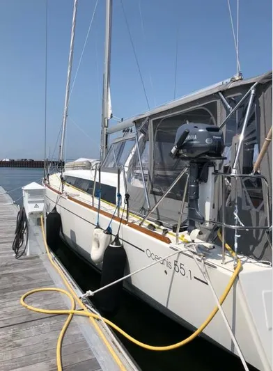 Cameli Yacht Photos Pics 2020 Beneteau Oceanis 55 sailboat docked at marina, side view.