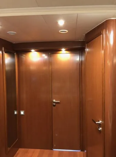 Cameli Yacht Photos Pics Interior hallway of 2020 Beneteau Oceanis 55 yacht with wooden finish.