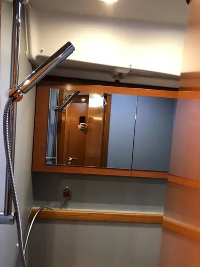 Cameli Yacht Photos Pics Interior of 2020 Beneteau Oceanis 55 yacht bathroom with mirror and showerhead.