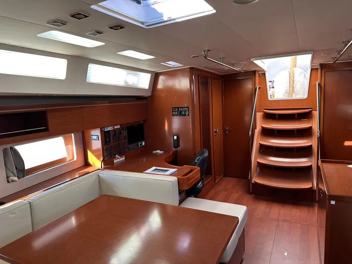 Cameli Yacht Photos Pics Interior of 2020 Beneteau Oceanis 55 yacht, featuring elegant wood finishes and spacious seating area.