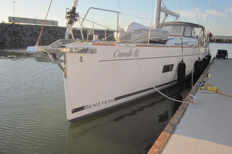 Cameli Yacht Photos Pics 2020 Beneteau Oceanis 55 sailboat docked at marina, side view.