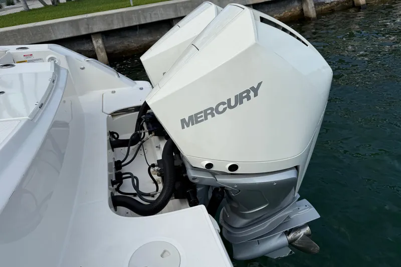  Yacht Photos Pics 2020 Boston Whaler 330 Outrage with dual Mercury outboard engines docked by water.