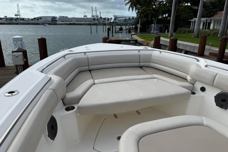  Yacht Photos Pics 2020 Boston Whaler 330 Outrage boat with spacious seating, docked by the waterfront.