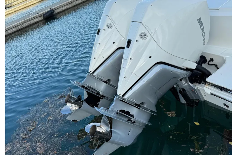  Yacht Photos Pics 2020 Boston Whaler 330 Outrage with dual outboard engines docked in marina.
