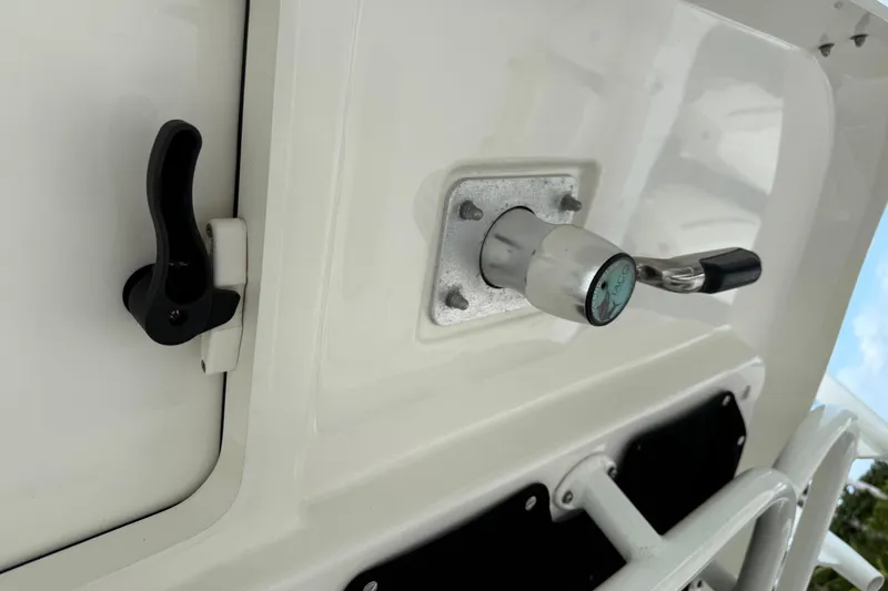  Yacht Photos Pics 2020 Boston Whaler 330 Outrage boat detail, featuring a latch and handle on a white surface.