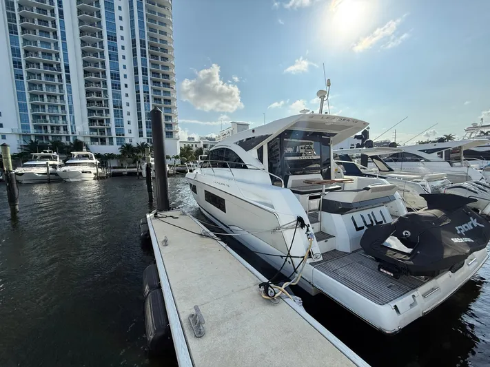 Luli Yacht Photos Pics 2017 Jeanneau Leader 46 yacht docked at marina with cityscape background.