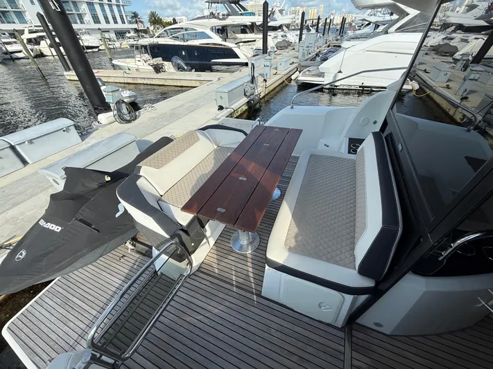 Luli Yacht Photos Pics 2017 Jeanneau Leader 46 yacht with outdoor seating and table at marina.