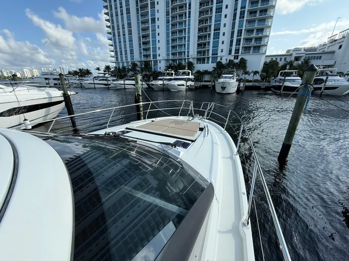 Luli Yacht Photos Pics 2017 Jeanneau Leader 46 yacht docked at marina with modern buildings in background.