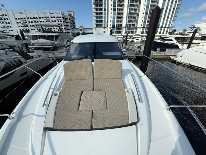 Luli Yacht Photos Pics 2017 Jeanneau Leader 46 yacht with sunbathing deck, docked in a marina.