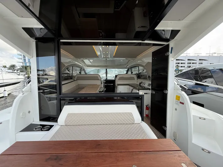 Luli Yacht Photos Pics 2017 Jeanneau Leader 46 yacht interior with seating and table.