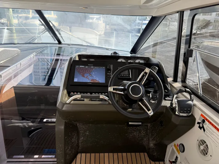 Luli Yacht Photos Pics 2017 Jeanneau Leader 46 helm with navigation system and steering wheel.