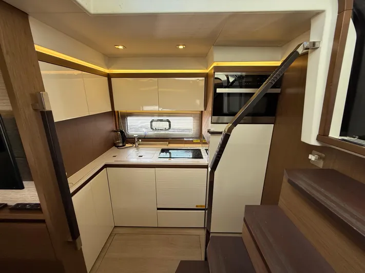 Luli Yacht Photos Pics Modern kitchen interior of 2017 Jeanneau Leader 46 yacht, featuring sleek cabinetry and appliances.