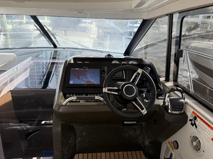 Luli Yacht Photos Pics 2017 Jeanneau Leader 46 helm with modern navigation system and steering wheel.