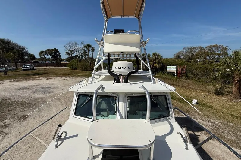  Yacht Photos Pics 2019 Parker 2520 XLD Sport Cabin boat with Garmin radar, parked outdoors.