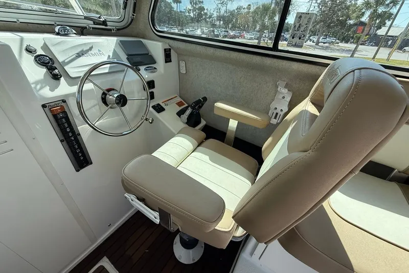  Yacht Photos Pics 2019 Parker 2520 XLD Sport Cabin interior with steering wheel and beige seating.