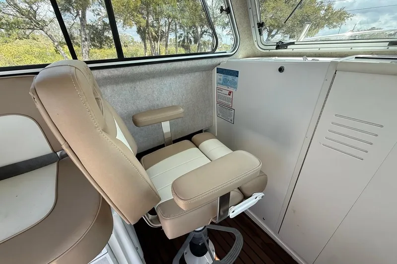  Yacht Photos Pics Interior of 2019 Parker 2520 XLD Sport Cabin with beige captain's chair and windows.