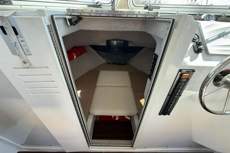  Yacht Photos Pics 2019 Parker 2520 XLD Sport Cabin interior with seating and control panel.