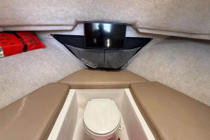  Yacht Photos Pics 2019 Parker 2520 XLD Sport Cabin interior with toilet and storage net.