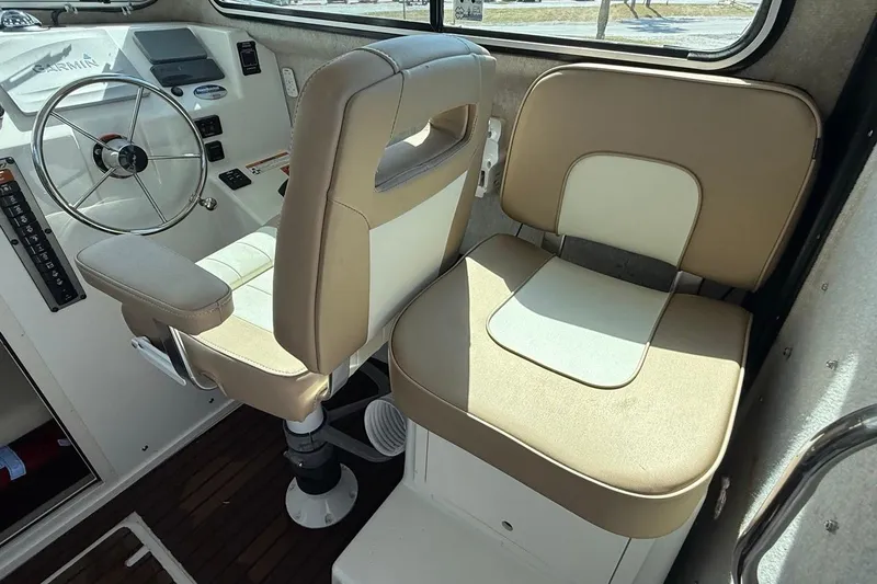  Yacht Photos Pics 2019 Parker 2520 XLD Sport Cabin interior with steering wheel and beige seating.