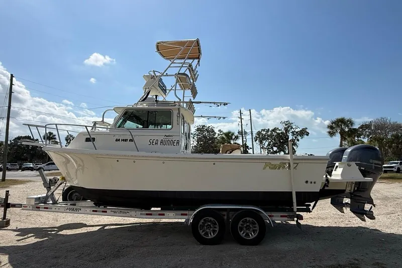  Yacht Photos Pics 2019 Parker 2520 XLD Sport Cabin boat on trailer, clear sky background.