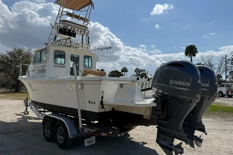  Yacht Photos Pics 2019 Parker 2520 XLD Sport Cabin boat with twin Yamaha engines on a trailer.