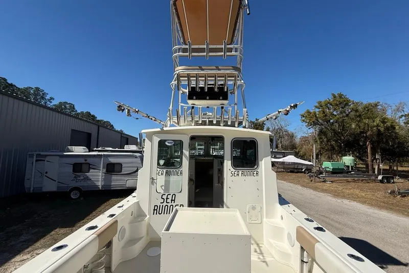  Yacht Photos Pics 2019 Parker 2520 XLD Sport Cabin boat with tower, parked outdoors.