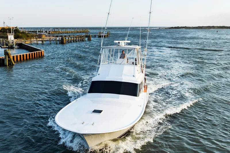 Leslie Ann Yacht Photos Pics 1988 Buddy Davis 47 Convertible yacht cruising on open water near a dock.