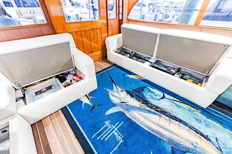 Leslie Ann Yacht Photos Pics Interior of 1988 Buddy Davis 47 Convertible with open storage and marlin-themed rug.